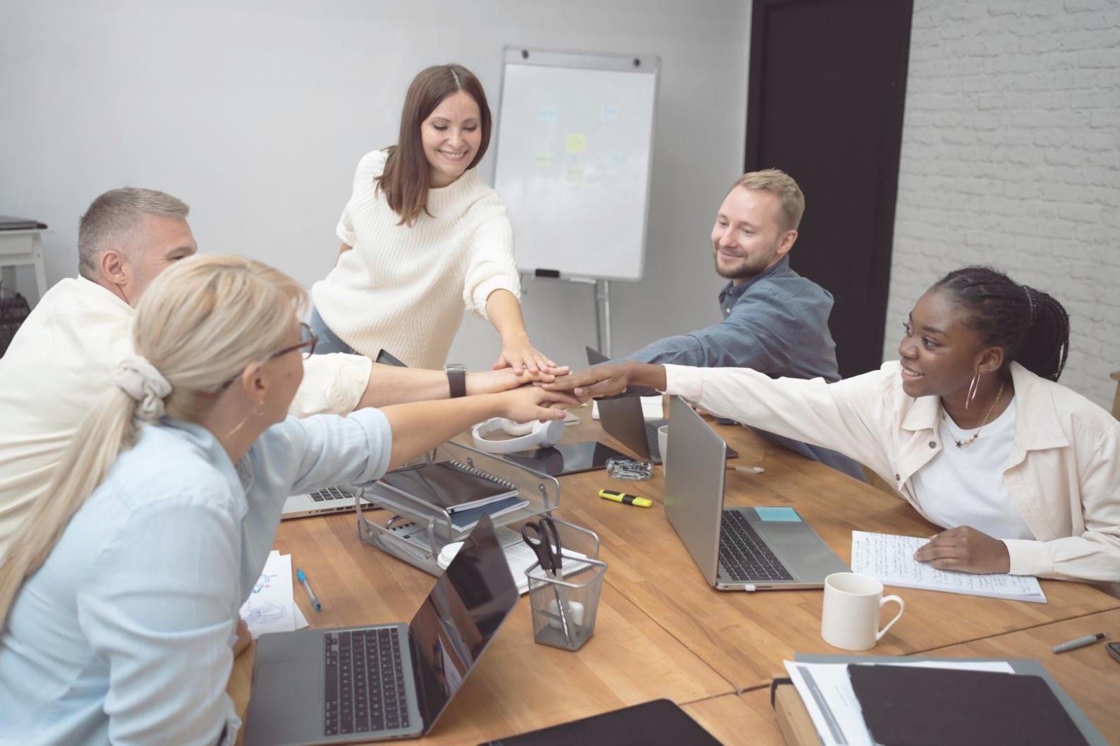 Business professionals reviewing financial documents and practicing presentation techniques